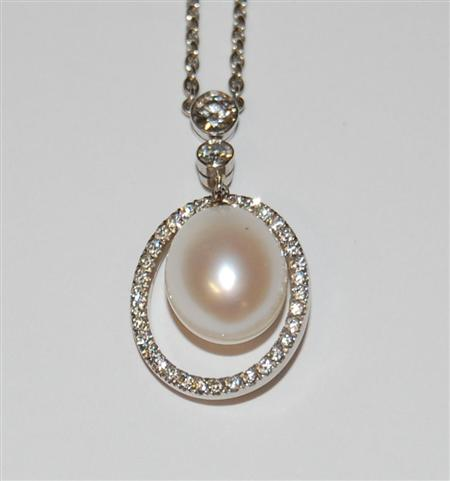A modern large cultured pearl and diamond set necklace collet