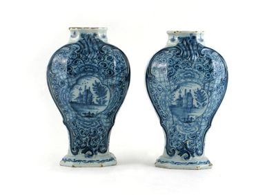 A pair of Dutch Delft octagonal baluster vases each painted