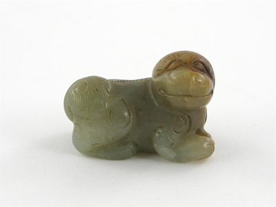 A small jade carving of a Buddhistic lion dog its