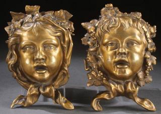 EXCEPTIONAL FRENCH GILT BRONZE MASK PLAQUES A PAIR OF EXCEPTIONAL