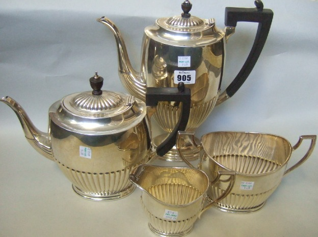 A silver four piece tea cum coffee set comprising a