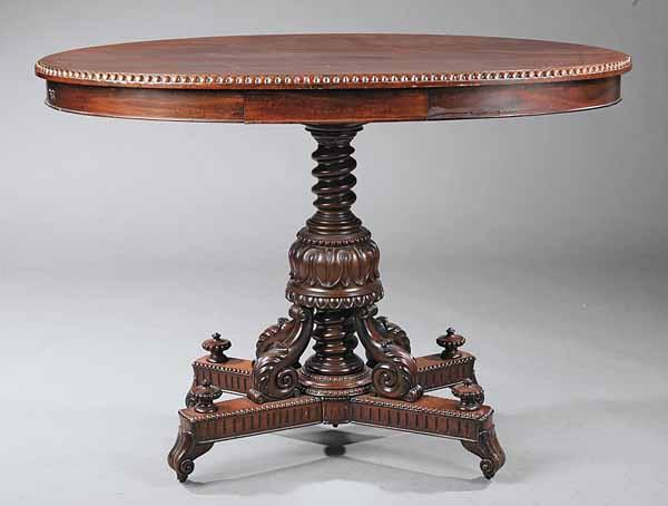 An American Renaissance Carved Mahogany Center Table the oval top