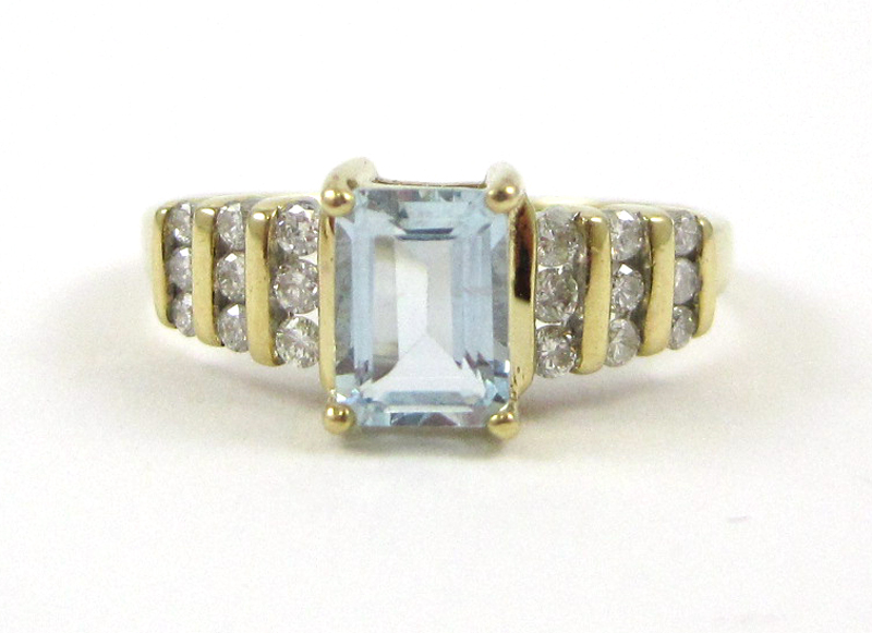 AQUAMARINE DIAMOND AND TEN KARAT GOLD RING with three rows