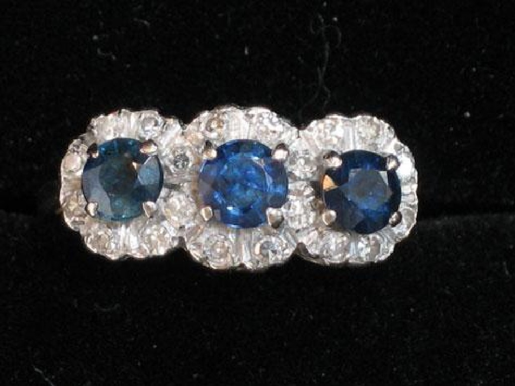 A SAPPHIRE AND DIAMOND TRIPLE CLUSTER RING the three round
