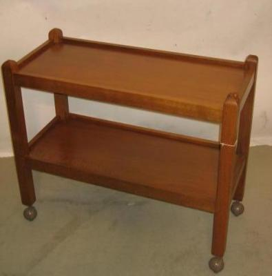 AN OAK TEA TROLLEY by Robert Mouseman Thompson of two