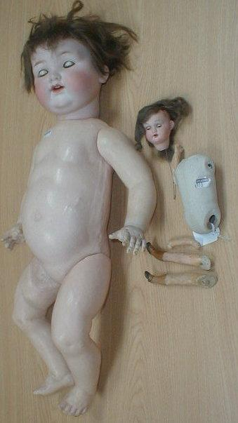 An Armand Marseille bisque head baby doll with a brown