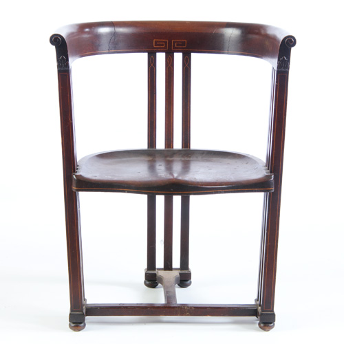 SECESSIONIST Inlaid mahogany barrel back armchair with a shaped seat