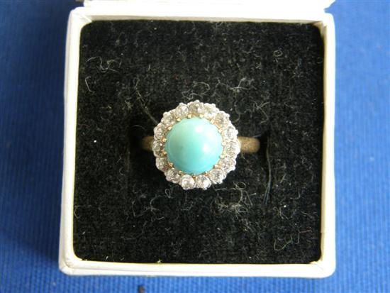 Cluster ring set with a cabochon turquoise and surrounded by