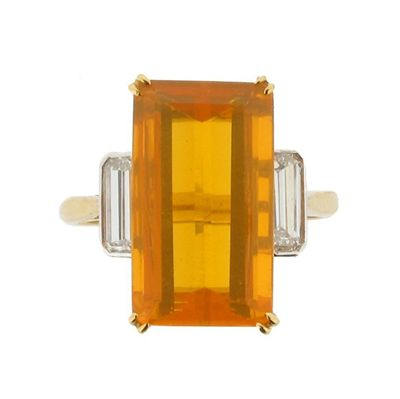A fire opal and diamond ring The emerald cut opal