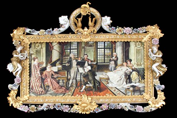 A porcelain paint decorated plaque in a porcelain and gilt
