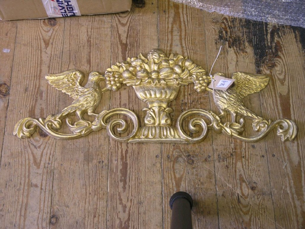 A pair of gilded cast iron door pediments cast with