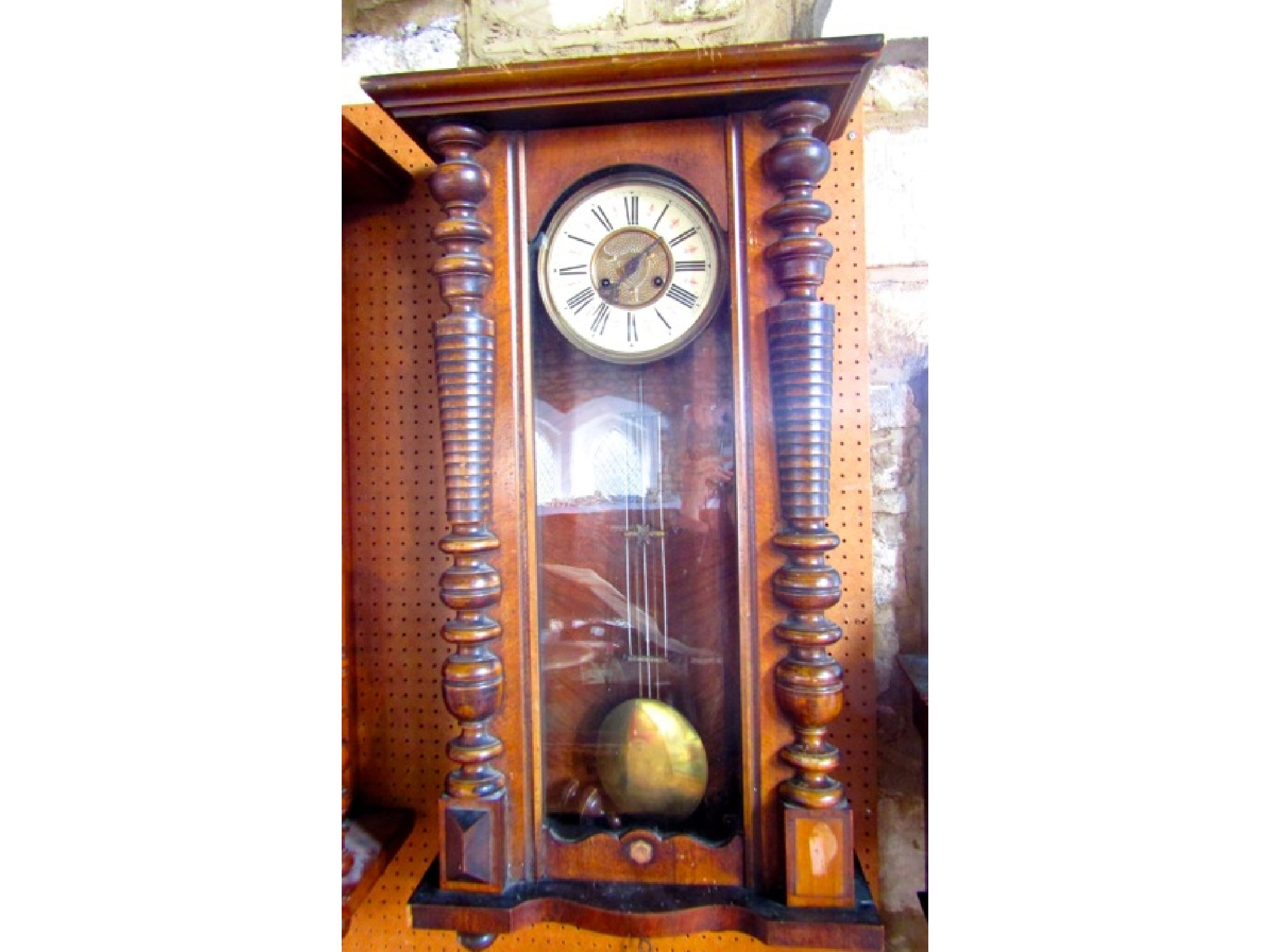 A 19th century walnut wall clock the case with split