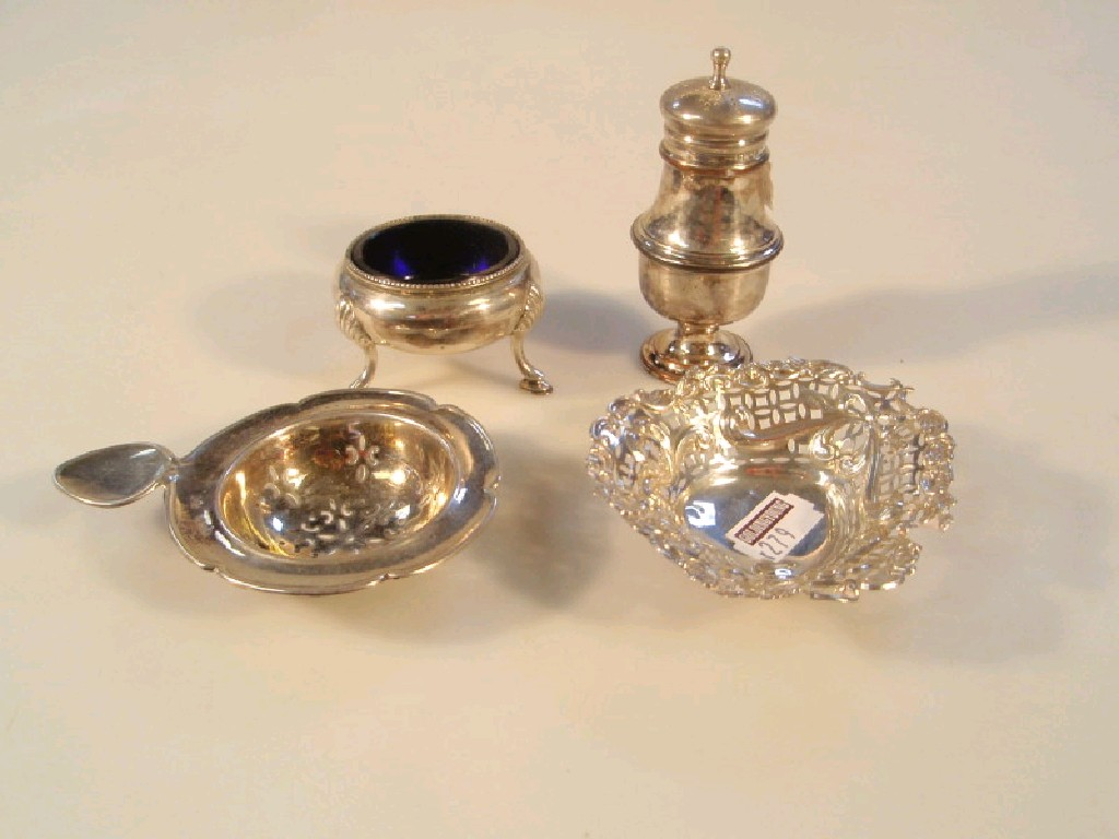 A Victorian silver salt with blue glass liner on three