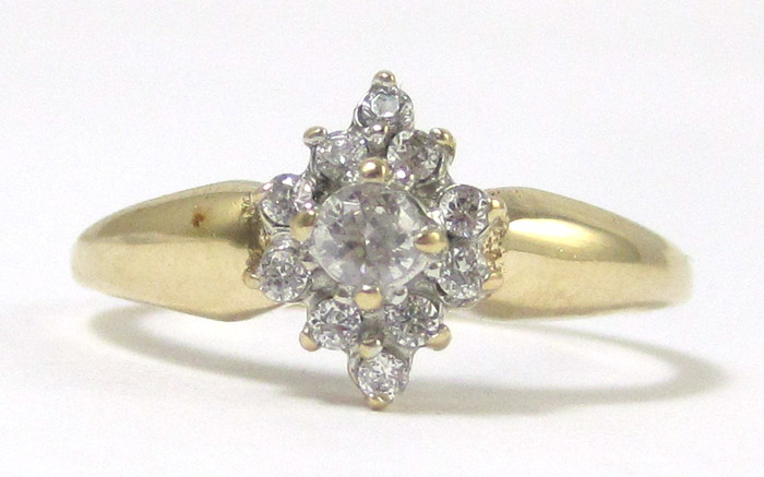 CUBIC ZIRCONIA AND TEN KARAT GOLD RING set with a