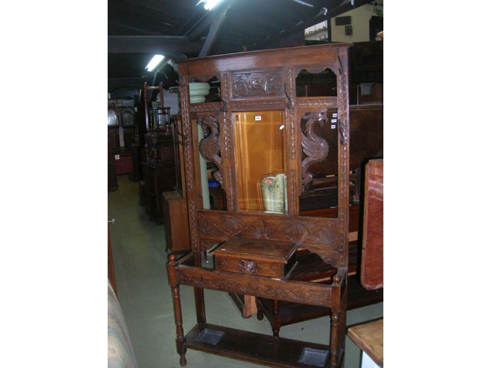 A Victorian oak hall stand of full height the raised