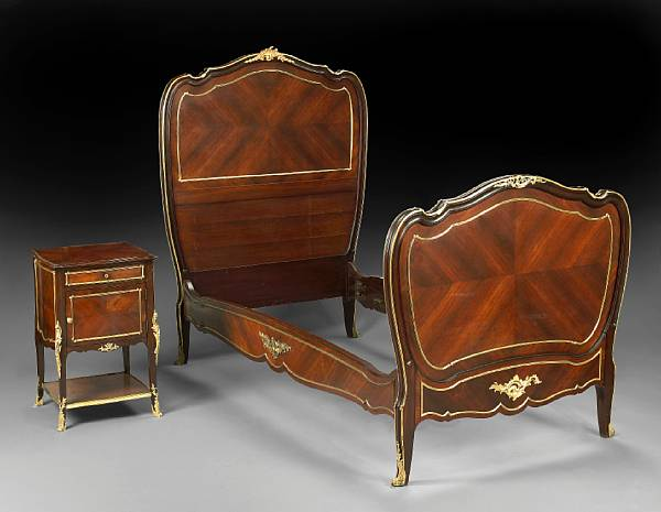 A Louis XV style gilt bronze mounted mahogany bed and