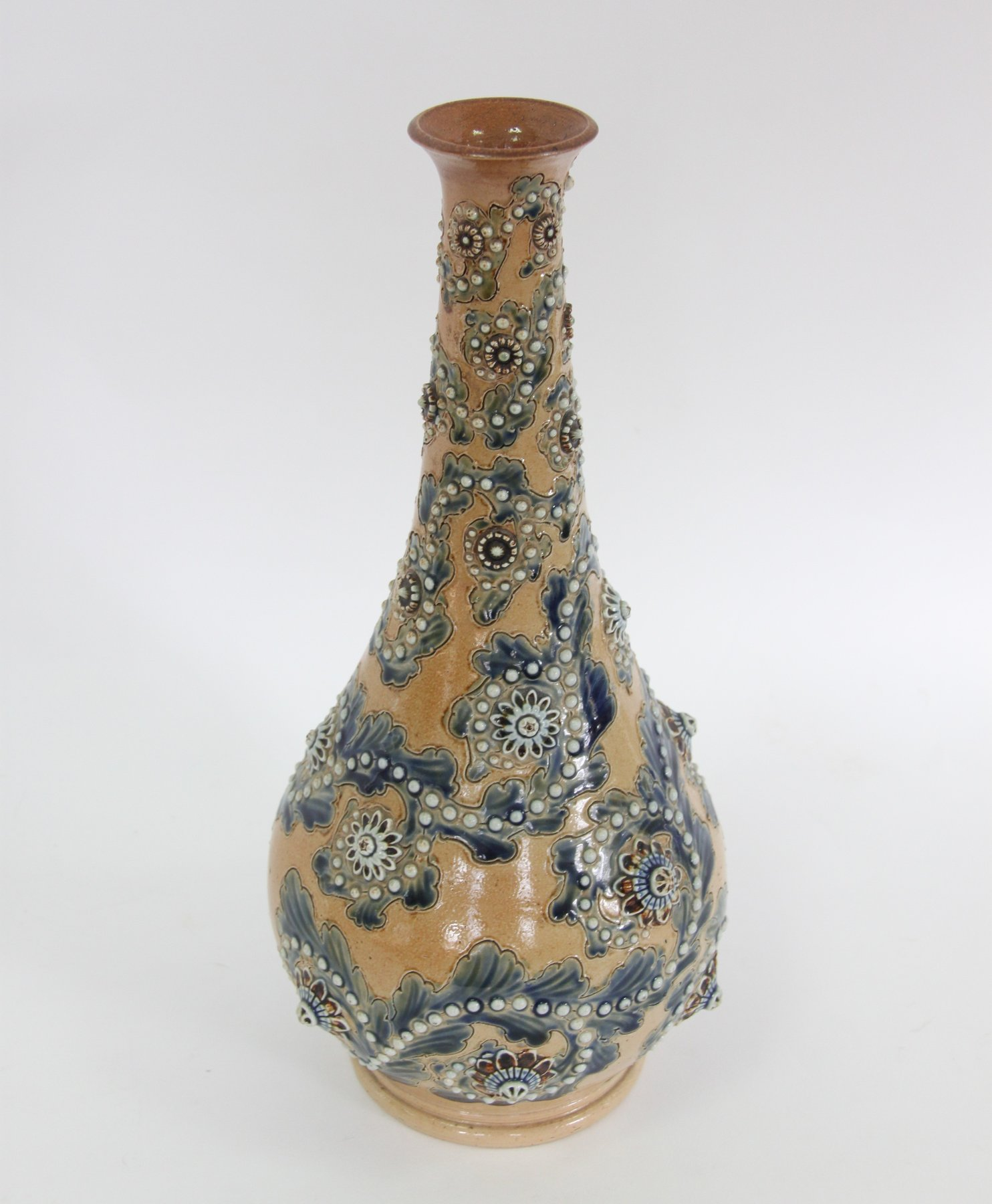 A Doulton Lambeth pear shaped vase decorated trailing blue foliage