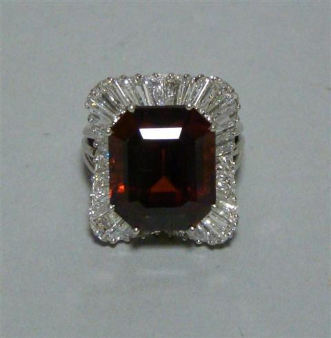 BALLERINA STYLE GARNET AND DIAMOND RING Emerald cut garnet approx