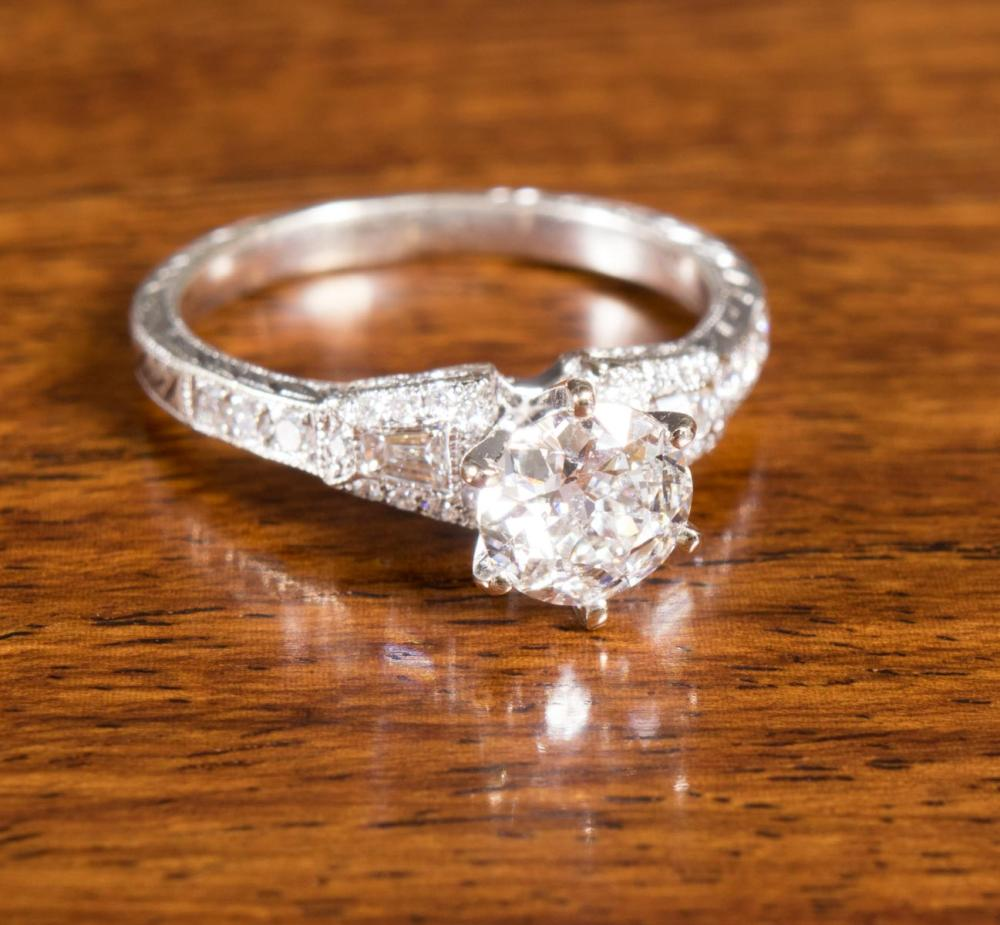 DIAMOND AND FOURTEEN KARAT WHITE GOLD RING with a tapered
