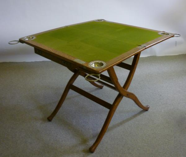 A VICTORIAN OAK CAMPAIGN CARD TABLE of rounded oblong folding