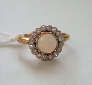 A gold opal and diamond set cluster ring collet set