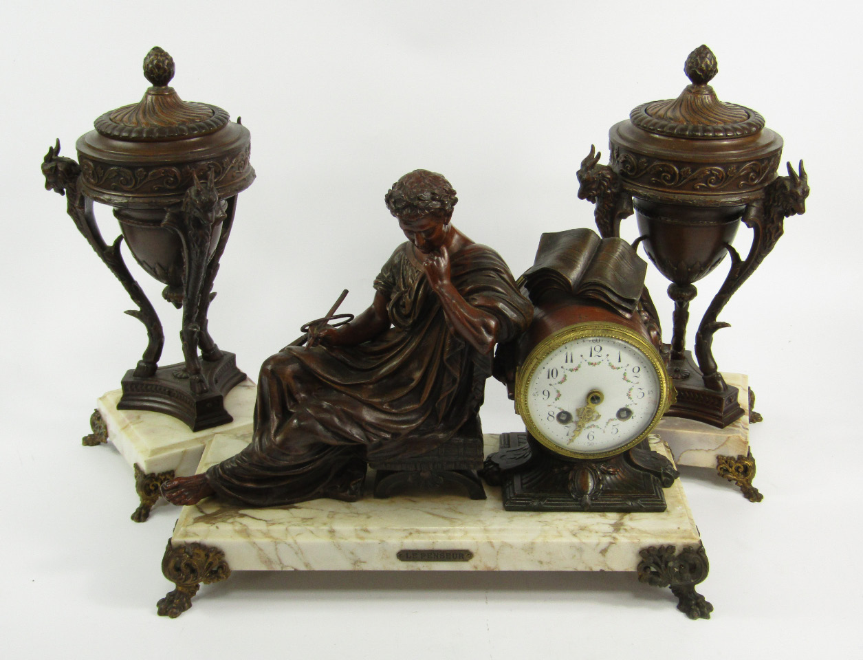 A late 19thC French bronzed spelter and marble clock garniture