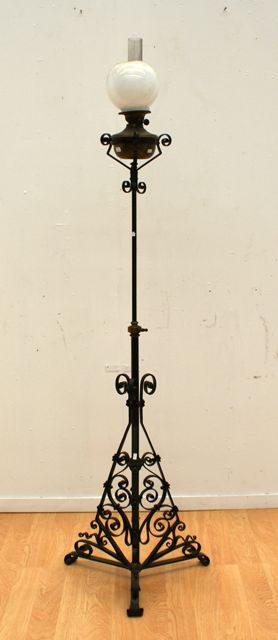 A French wrought iron standard lamp with adjustable column