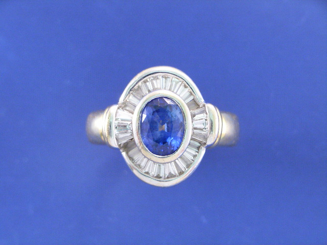 An 18ct bi tone gold sapphire and baguette cut diamond