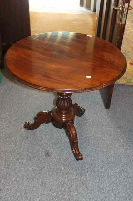 A VICTORIAN MAHOGANY CIRCULAR TIP UP OCCASIONAL TABLE with a
