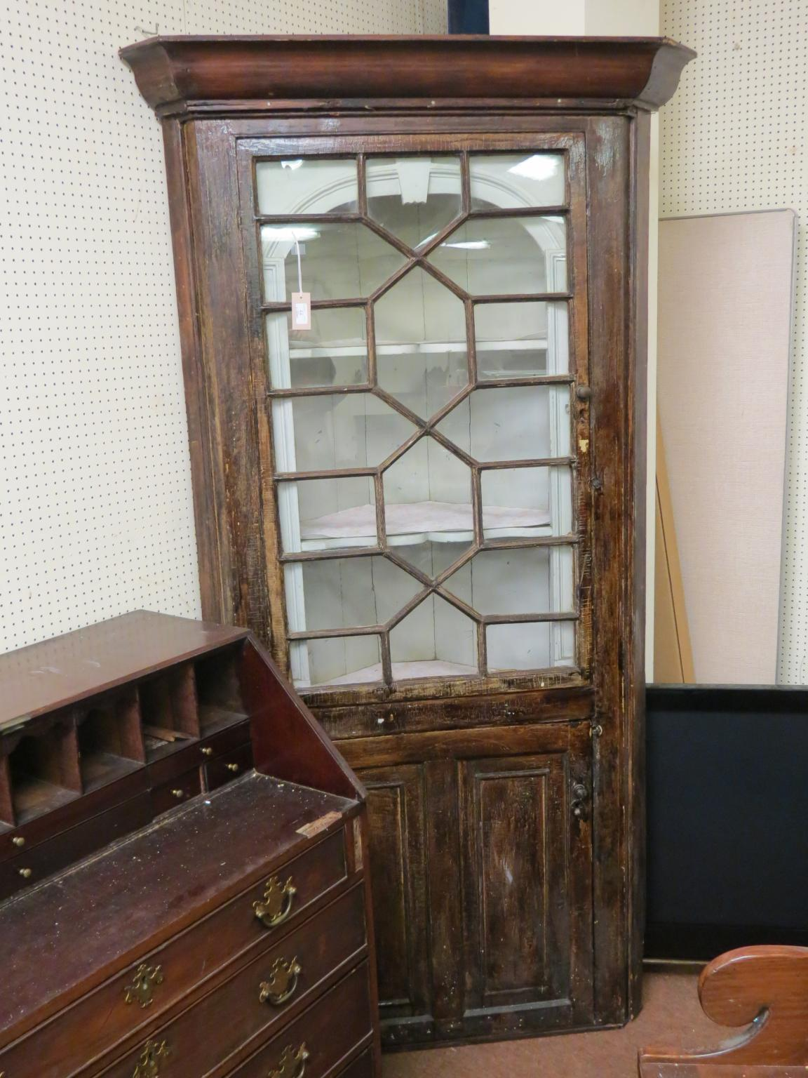 A Georgian stained pine standing corner cabinet astragal glazed single