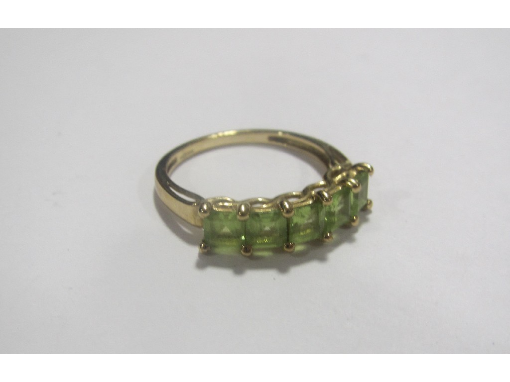 Nine carat gold peridot five stone ring