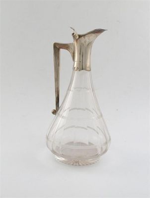 A modern mounted glass decanter with angular handle hinged cover