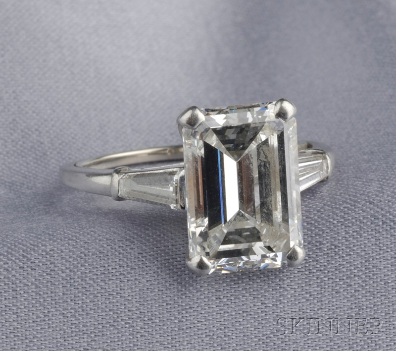 Platinum and Diamond Solitaire prong set with an emerald cut