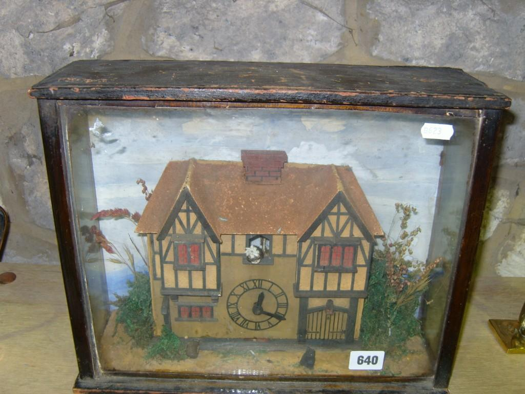 A naive 19th century wall mounted clock in the form