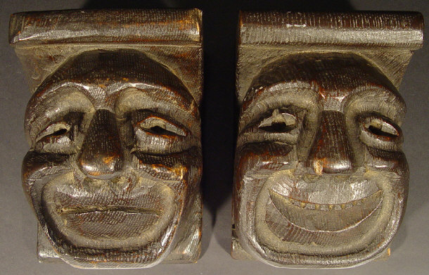 Two oak wall brackets carved with grotesque faces each 18cm