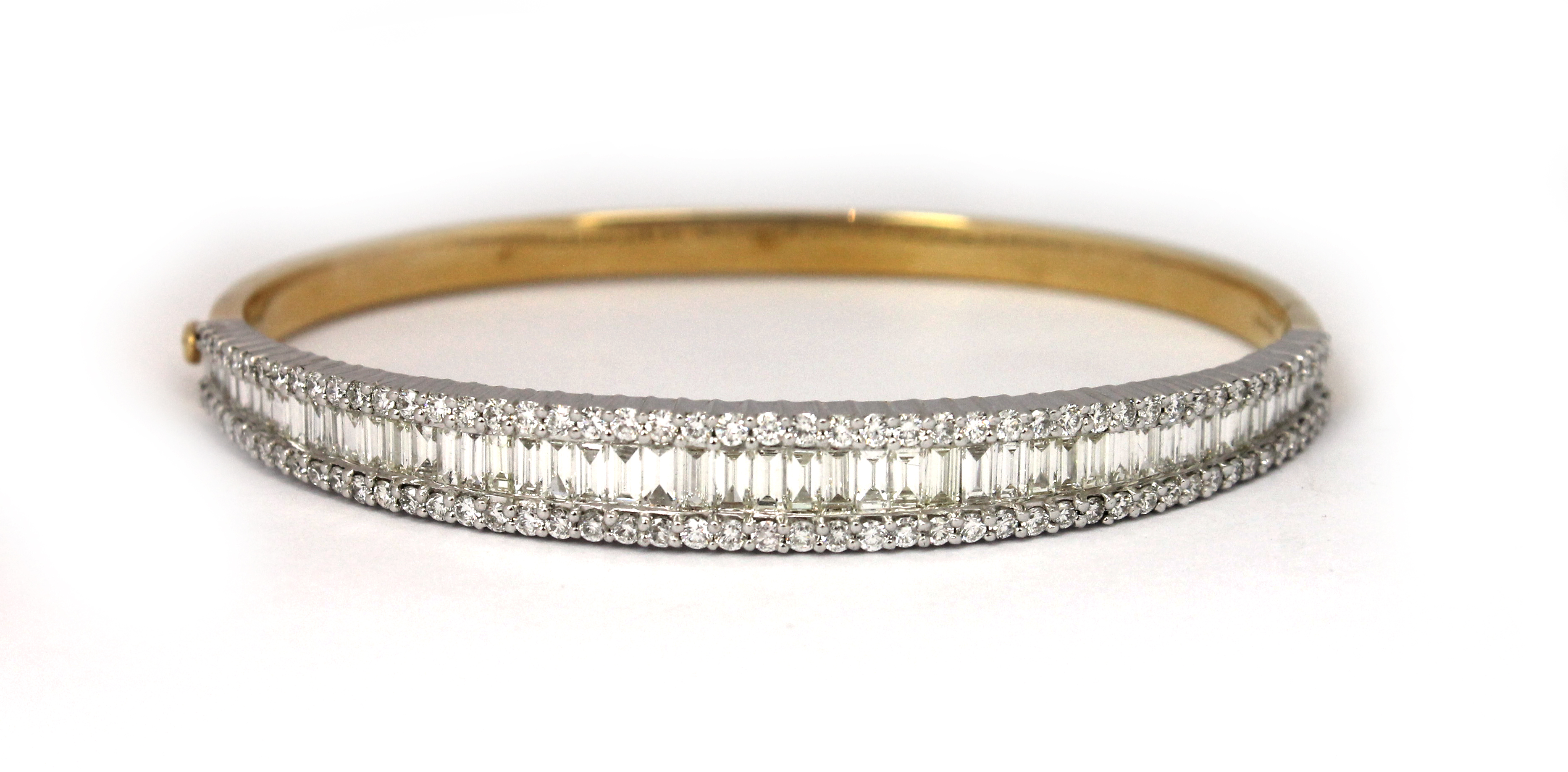 An 18ct gold and diamond set oval hinged bangle the