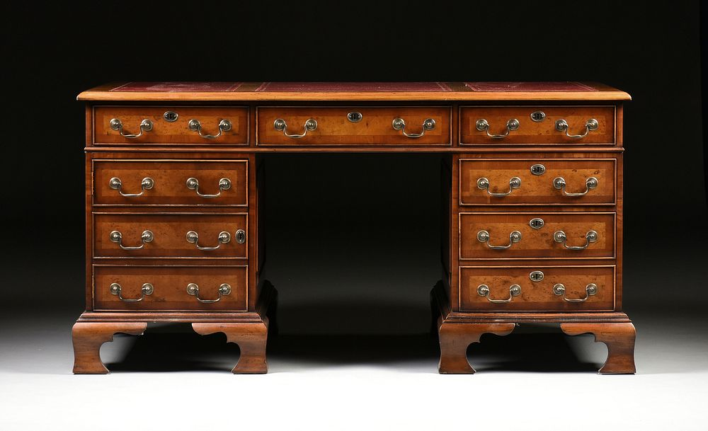 A GEORGE II STYLE WALNUT BURGUNDY LEATHER TOP PARTNER S