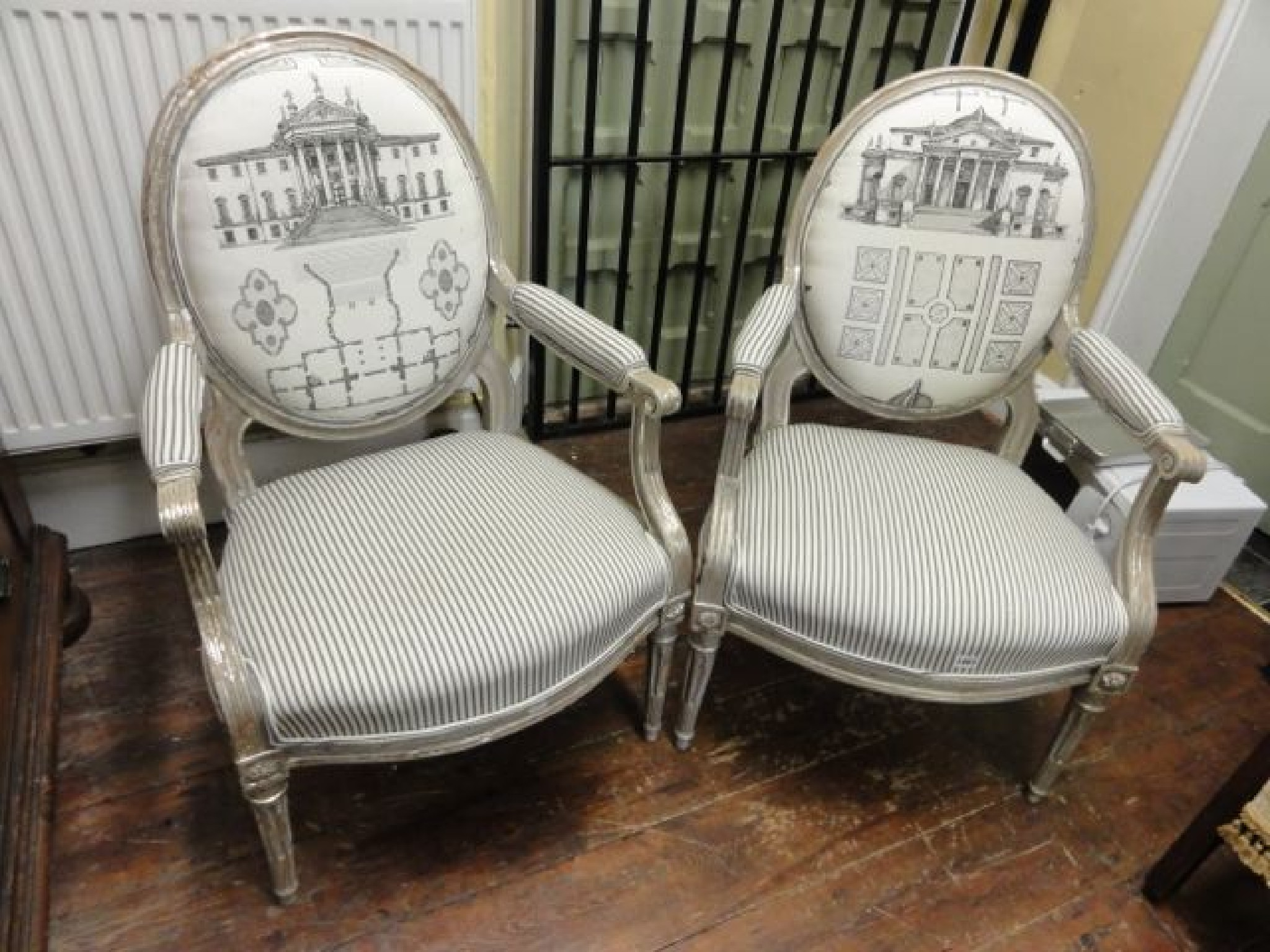 A pair of neo classical design open elbow chairs with