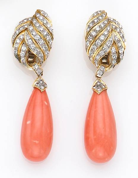 each pendant earring featuring a drop shaped piece of coral