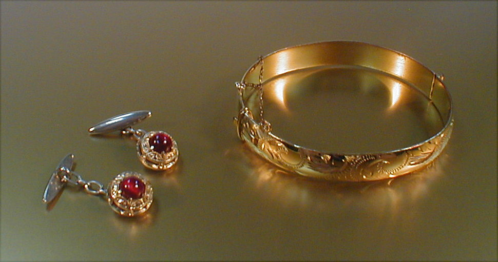 A hinged rolled gold bangle together with a pair of
