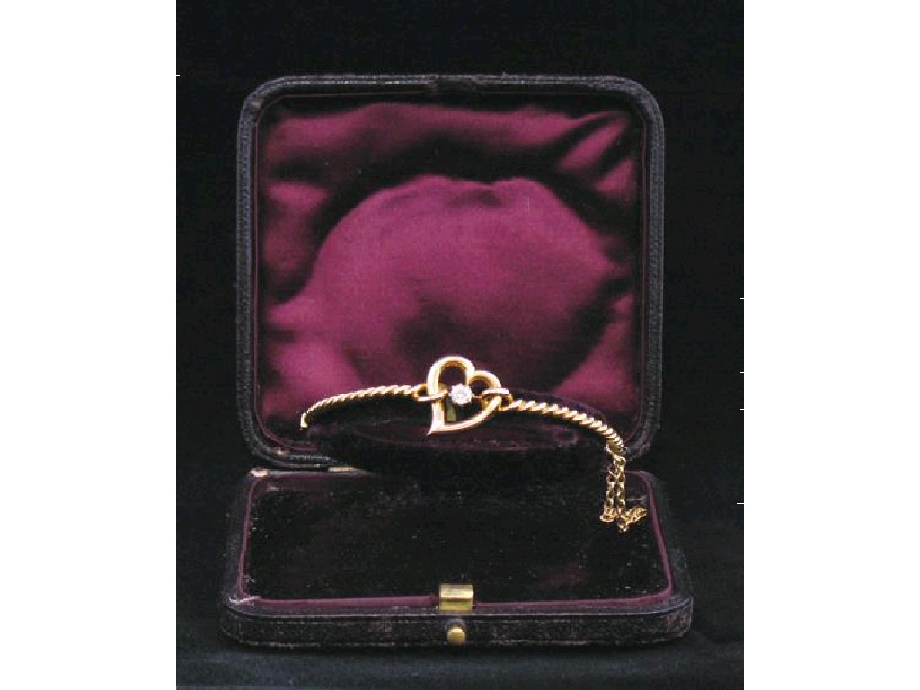 A 15CT YELLOW GOLD BANGLE of rope twist design and