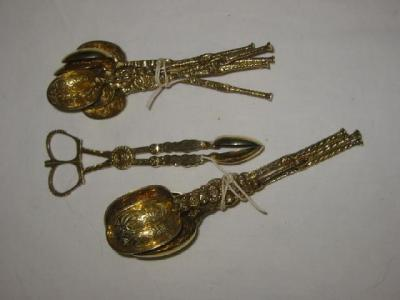 A PAIR OF SILVER GILT SUGAR NIPS the bowls chased