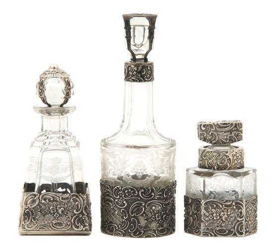 Group of Three Continental Etched Glass and Silver Overlay Bottles