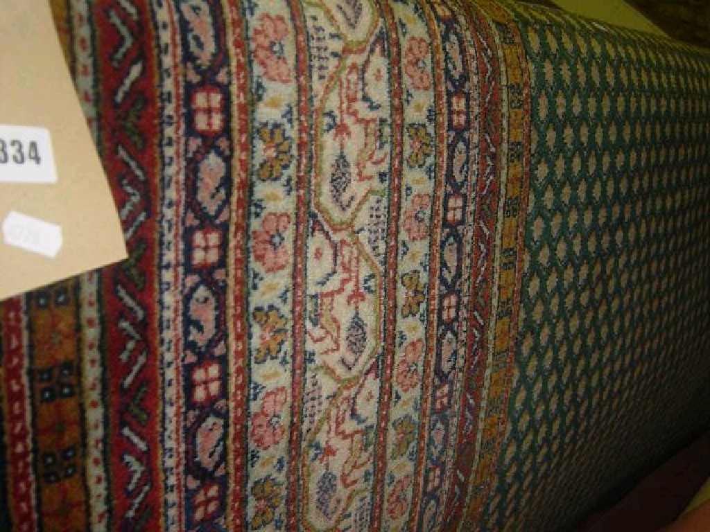 A green ground wool carpet in the Eastern style with