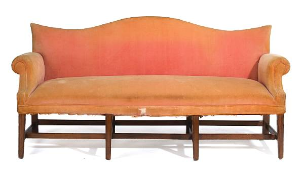 The serpentine arched back above overscrolled arms and a rectangular