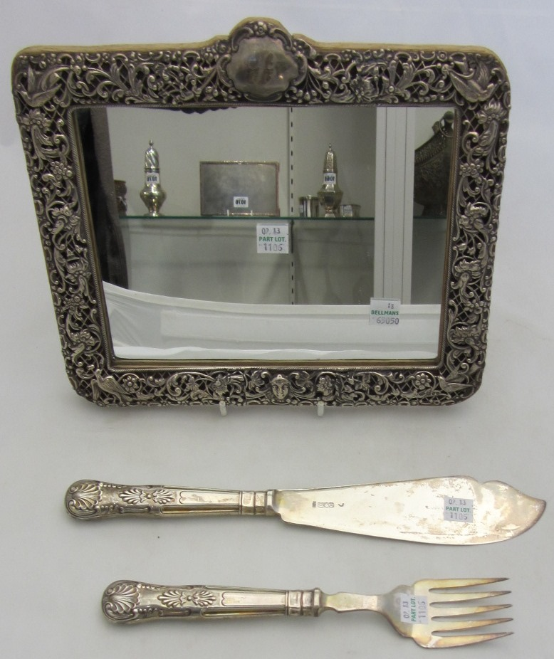 A Victorian silver mounted shaped rectangular mirror decorated and pierced