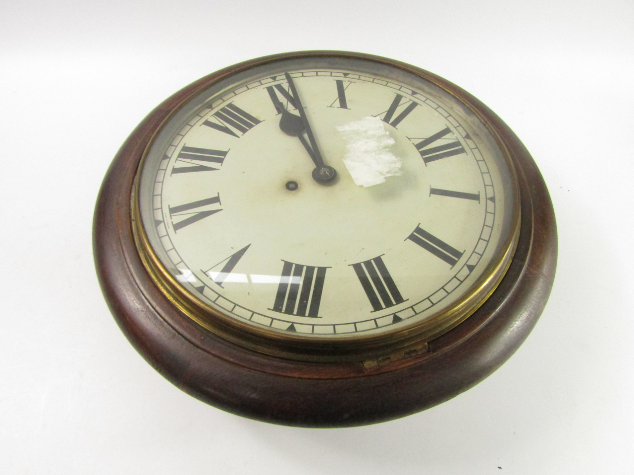 An oak cased early 20thC circular wall clock dial bearing