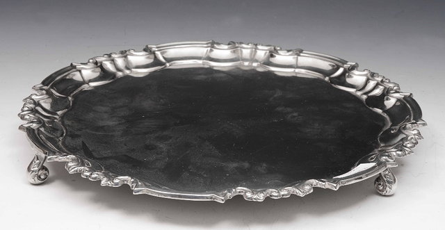 A Georgian style silver salverof circular form with raised border