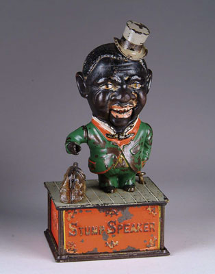STUMP SPEAKER MECHANICAL BANK The bank depicts a black carpet