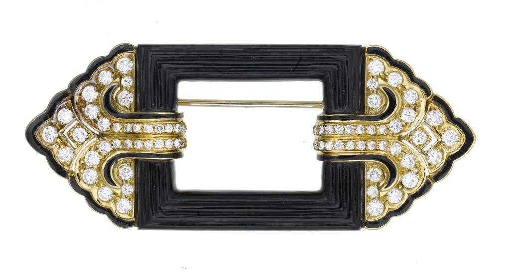 A DIAMOND ONYX AND GOLD AND ENAMEL BROOCH of geometric